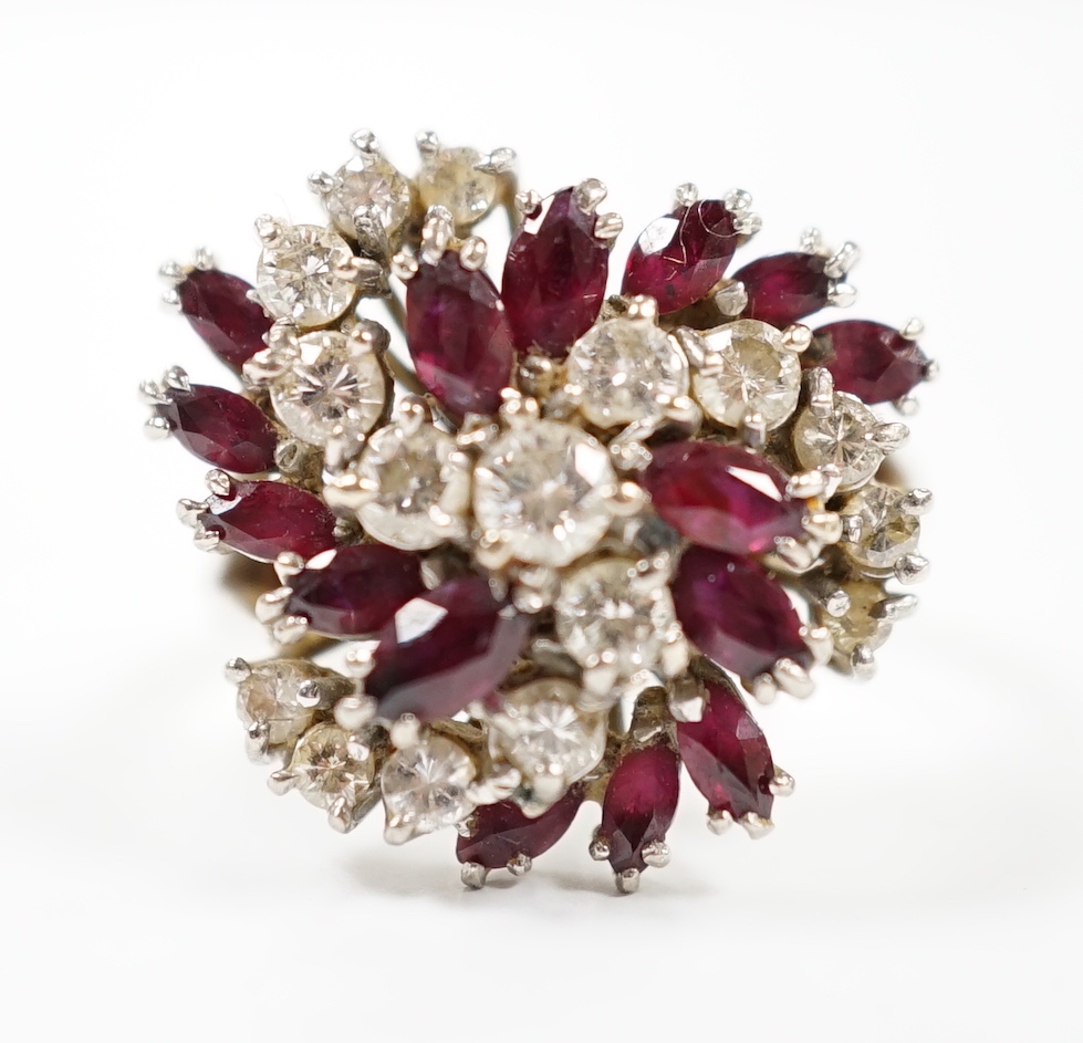 An 18ct, ruby and diamond set spiral cluster ring, size O, gross weight 7.7 grams.